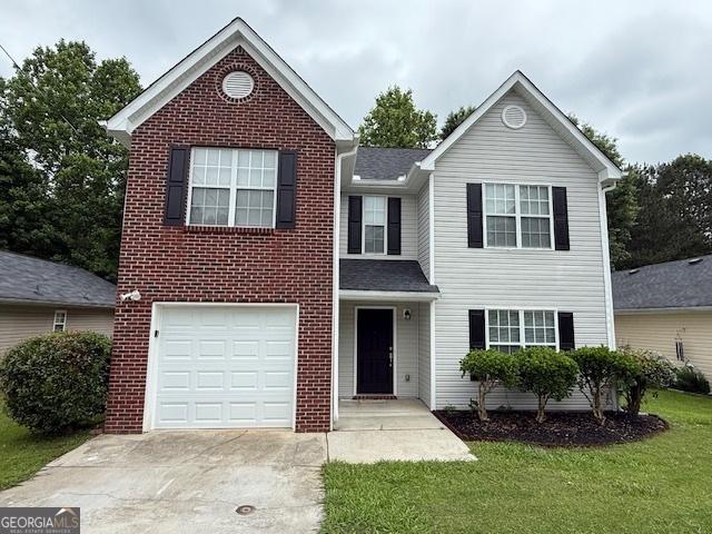 7006 Mahonia Pl, Lithonia, GA 30038 - traditional-style house featuring concrete driveway, brick siding, a garage, and a front lawn