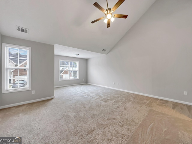 7006 Mahonia Pl, Lithonia, GA 30038 - unfurnished living room with carpet floors, baseboards, a ceiling fan, and vaulted ceiling