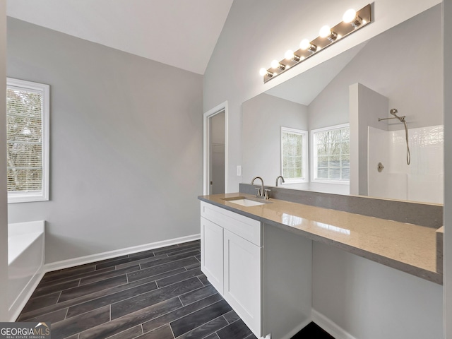 7006 Mahonia Pl, Lithonia, GA 30038 - bathroom with vaulted ceiling, a shower, wood tiled floors, baseboards, and vanity