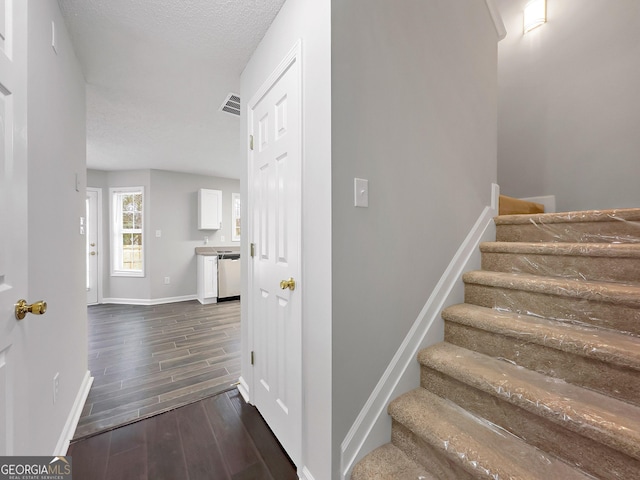 7006 Mahonia Pl, Lithonia, GA 30038 - stairway featuring wood finished floors, baseboards, and a textured ceiling