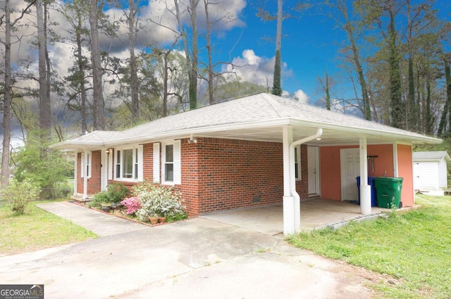 1693 Montreal Rd, Tucker, GA 30084 - view of front of property with concrete driveway, brick siding, a front yard, and an attached carport