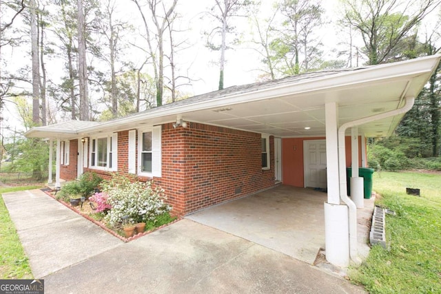 1693 Montreal Rd, Tucker, GA 30084 - view of side of property with brick siding, concrete driveway, and an attached carport