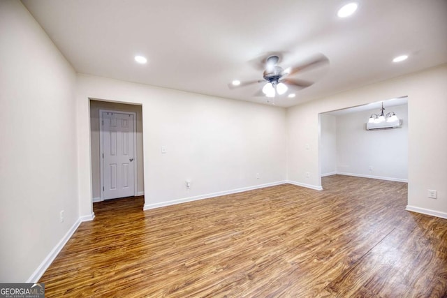 1693 Montreal Rd, Tucker, GA 30084 - empty room with a ceiling fan, wood finished floors, recessed lighting, baseboards, and a chandelier