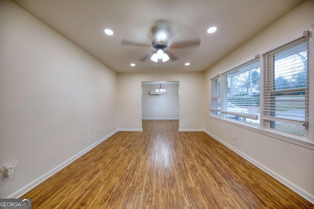 1693 Montreal Rd, Tucker, GA 30084 - unfurnished room with a ceiling fan, wood finished floors, baseboards, recessed lighting, and a chandelier