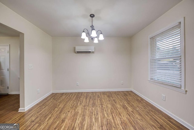 1693 Montreal Rd, Tucker, GA 30084 - unfurnished room featuring a wall mounted air conditioner, wood finished floors, a chandelier, and baseboards