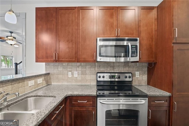 221 Semel Cir NW Unit 273, Atlanta, GA 30309 - kitchen with appliances with stainless steel finishes, a sink, a ceiling fan, decorative backsplash, and light stone counters