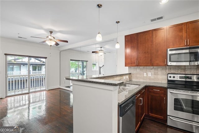 221 Semel Cir NW Unit 273, Atlanta, GA 30309 - kitchen with stainless steel appliances, ceiling fan, stone countertops, a peninsula, and backsplash