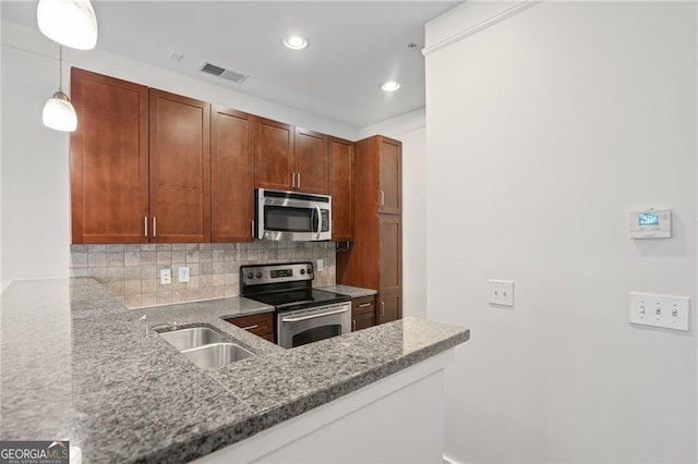 221 Semel Cir NW Unit 273, Atlanta, GA 30309 - kitchen featuring stainless steel appliances, a sink, backsplash, light stone countertops, and recessed lighting