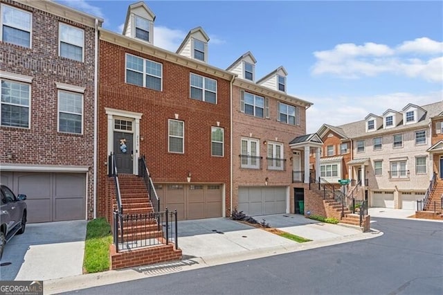 2690 Derby Walk NE Unit 53, Atlanta, GA 30319 - multi unit property featuring brick siding, stairway, a residential view, driveway, and a garage