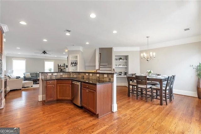 2690 Derby Walk NE Unit 53, Atlanta, GA 30319 - kitchen with stainless steel dishwasher, a chandelier, open floor plan, a ceiling fan, and a kitchen island