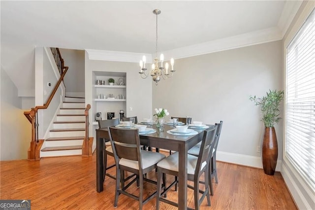 2690 Derby Walk NE Unit 53, Atlanta, GA 30319 - dining room with stairs, light wood finished floors, a chandelier, built in shelves, and plenty of natural light