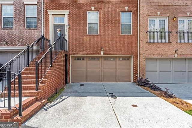 2690 Derby Walk NE Unit 53, Atlanta, GA 30319 - view of front of property featuring driveway, an attached garage, and brick siding