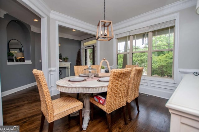 dining room with crown molding, a chandelier, dark wood-type flooring, and recessed lighting