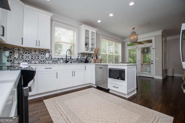 kitchen featuring stainless steel dishwasher, black microwave, ornamental molding, recessed lighting, and light countertops