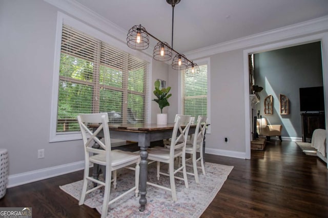 dining area featuring healthy amount of natural light, baseboards, ornamental molding, and wood finished floors