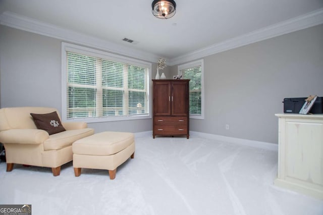 living area featuring ornamental molding, light colored carpet, and baseboards