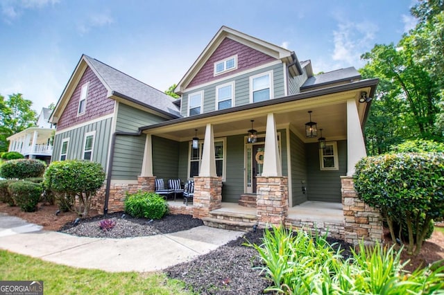 view of front of house featuring covered porch and stone siding