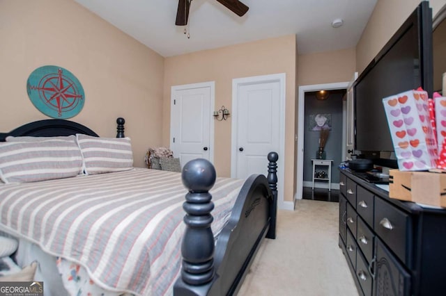 bedroom with light carpet, a ceiling fan, and baseboards