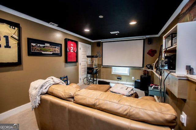 carpeted home theater room featuring crown molding, baseboards, and recessed lighting