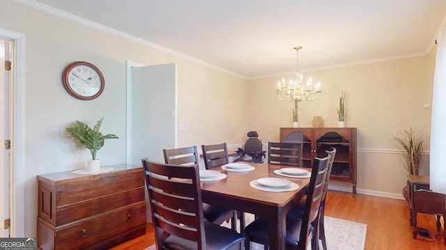 dining space featuring a chandelier, light wood finished floors, baseboards, and ornamental molding
