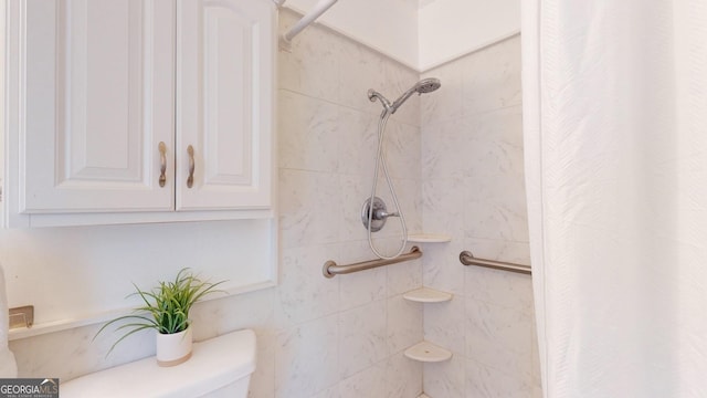 bathroom with a shower with shower curtain and toilet