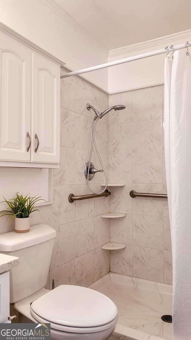 full bath featuring toilet, a shower stall, ornamental molding, and vanity