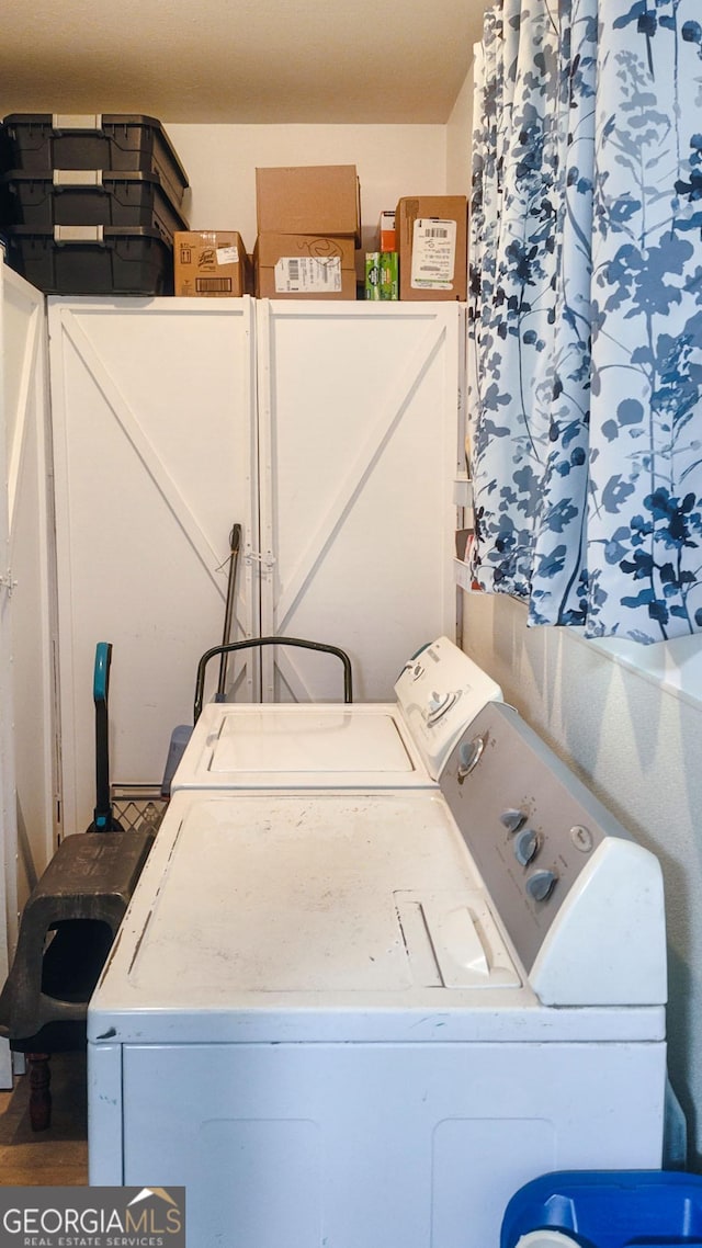 laundry area with independent washer and dryer