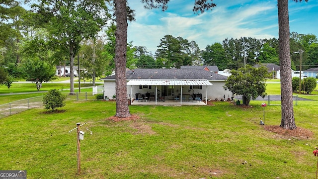 back of property featuring a patio and view of scattered trees