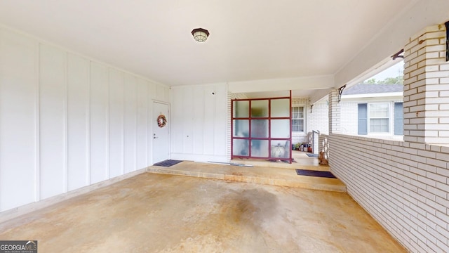 property entrance with brick siding and covered porch