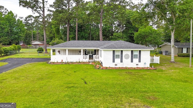 single story home with roof with shingles, crawl space, brick siding, and view of wooded area