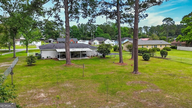 view of yard featuring a patio, a residential view, and view of scattered trees