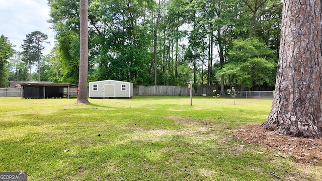 view of yard with an outdoor structure, a storage unit, and view of scattered trees
