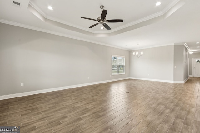 125 The Villas Way, Kingsland, GA 31548 - unfurnished room featuring a tray ceiling, wood finished floors, a chandelier, a ceiling fan, and baseboards