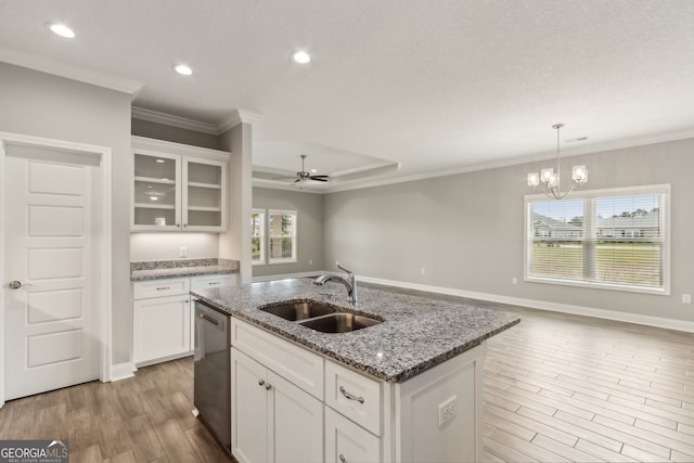 125 The Villas Way, Kingsland, GA 31548 - kitchen with stainless steel dishwasher, light wood finished floors, open floor plan, white cabinets, and crown molding