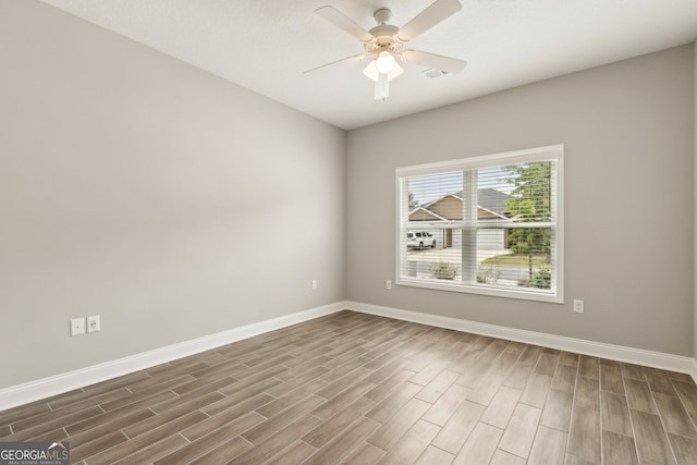 125 The Villas Way, Kingsland, GA 31548 - spare room with dark wood-style floors, baseboards, and a ceiling fan