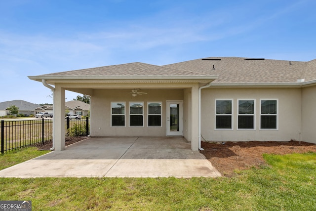 125 The Villas Way, Kingsland, GA 31548 - back of property featuring ceiling fan, stucco siding, roof with shingles, and a patio area