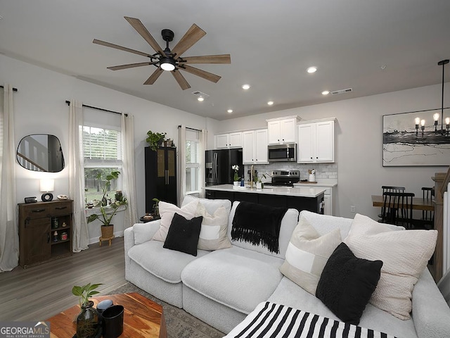 2108 Remy Ct, Kennesaw, GA 30144 - living room featuring wood finished floors, a ceiling fan, a chandelier, and recessed lighting