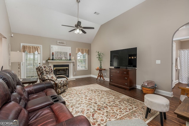 900 Bay Laurel Cir, Warner Robins, GA 31088 - living area with a ceiling fan, high vaulted ceiling, healthy amount of natural light, dark wood-type flooring, and a glass covered fireplace