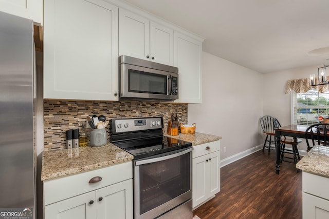 900 Bay Laurel Cir, Warner Robins, GA 31088 - kitchen featuring stainless steel appliances, baseboards, tasteful backsplash, dark wood-type flooring, and white cabinetry