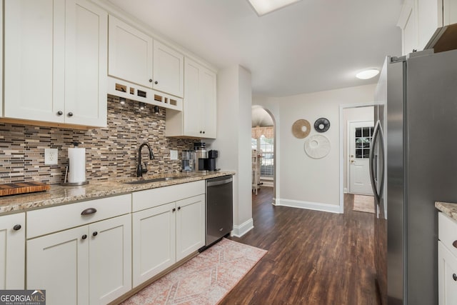 900 Bay Laurel Cir, Warner Robins, GA 31088 - kitchen featuring a sink, appliances with stainless steel finishes, arched walkways, dark wood finished floors, and baseboards