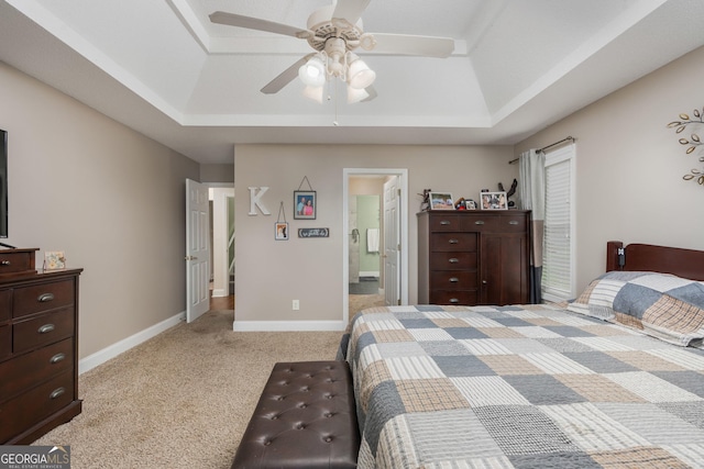 900 Bay Laurel Cir, Warner Robins, GA 31088 - bedroom with a tray ceiling, carpet floors, baseboards, connected bathroom, and a ceiling fan