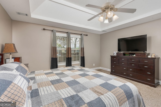 900 Bay Laurel Cir, Warner Robins, GA 31088 - bedroom featuring a raised ceiling, light carpet, ceiling fan, and baseboards