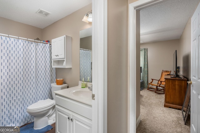 900 Bay Laurel Cir, Warner Robins, GA 31088 - bathroom featuring vanity, toilet, a shower with shower curtain, and a textured ceiling