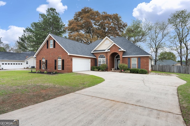 900 Bay Laurel Cir, Warner Robins, GA 31088 - traditional home with brick siding, driveway, a garage, and roof with shingles