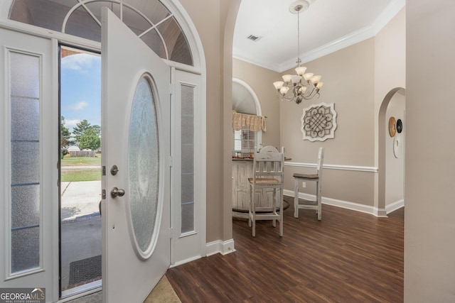 900 Bay Laurel Cir, Warner Robins, GA 31088 - entrance foyer featuring arched walkways, ornamental molding, dark wood finished floors, healthy amount of natural light, and a chandelier