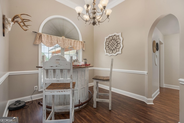 900 Bay Laurel Cir, Warner Robins, GA 31088 - dining space with a chandelier, wood finished floors, arched walkways, baseboards, and crown molding