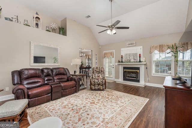 900 Bay Laurel Cir, Warner Robins, GA 31088 - living area featuring a ceiling fan, dark wood-style flooring, baseboards, a glass covered fireplace, and high vaulted ceiling