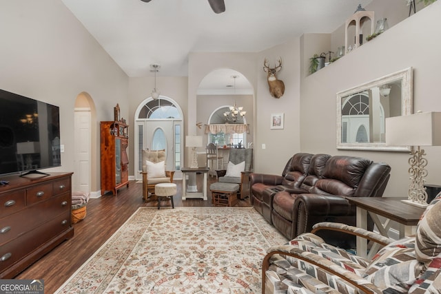 900 Bay Laurel Cir, Warner Robins, GA 31088 - living area featuring arched walkways, dark wood-style floors, a chandelier, ceiling fan, and a towering ceiling