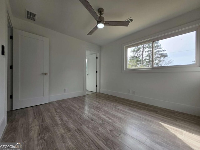 2400 Glenrock Dr, Decatur, GA 30032 - unfurnished bedroom with wood finished floors, baseboards, and a ceiling fan