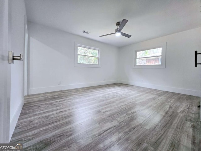 2400 Glenrock Dr, Decatur, GA 30032 - empty room with healthy amount of natural light, wood finished floors, and ceiling fan